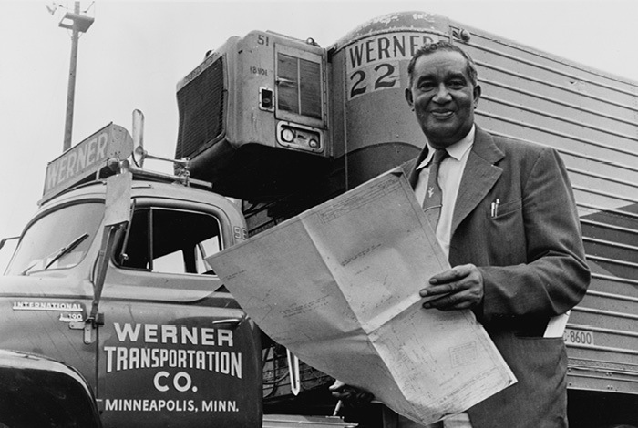 Frederick McKinley Jones standing in front of a Werner Transportation refrigerated truck