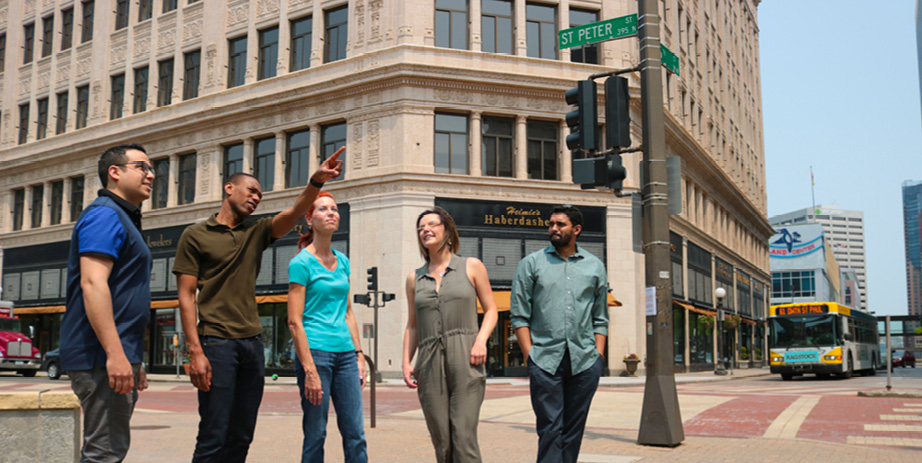 Tour guide pointing at buildings.