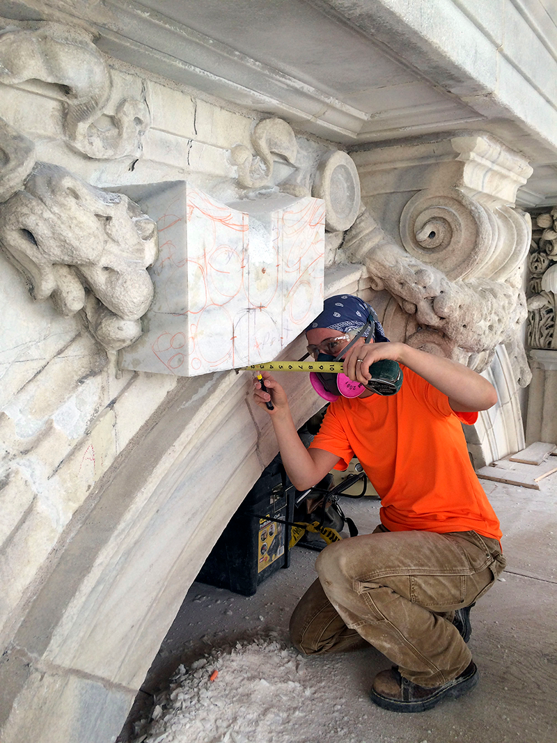 A master carver measuring dimensions to carve a festoon on the Capitol’s exterior.