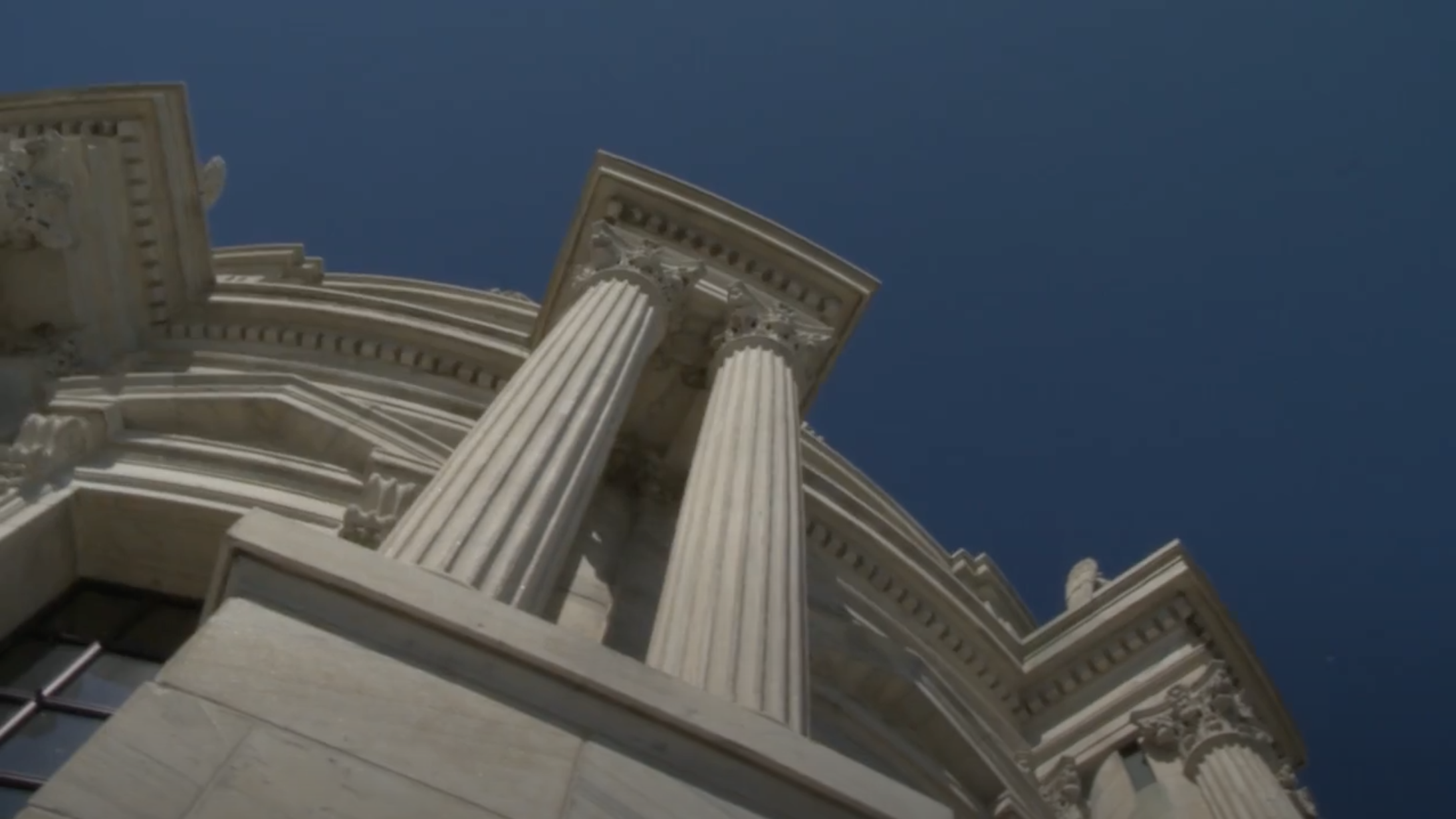 Still of State Capitol exterior.